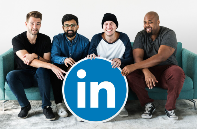 Diverse B2B team holding a LinkedIn logo, representing human-led LinkedIn lead generation.